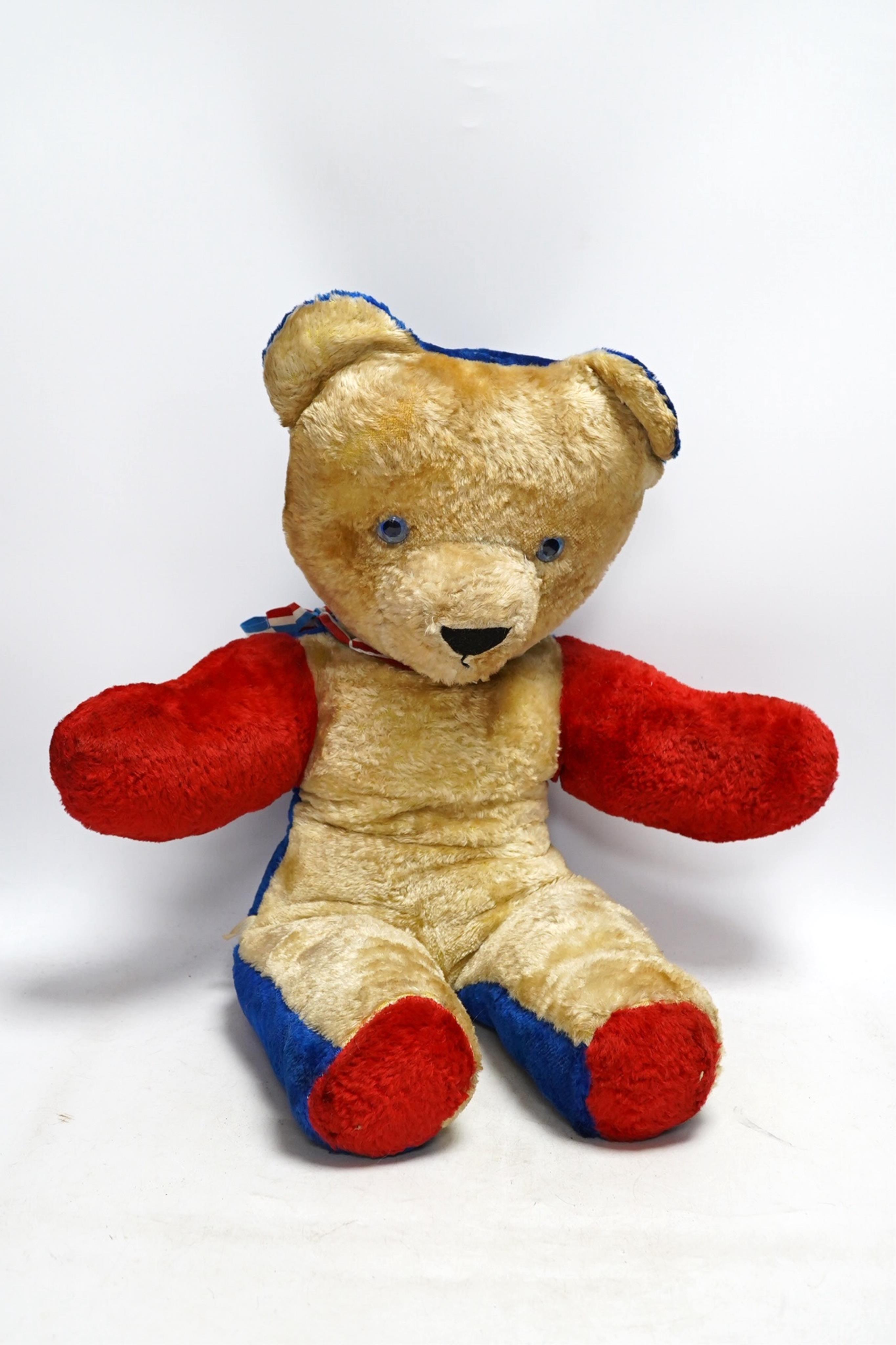 A large Chad Valley bear, c.1930's, label on foot, hair loss, restored paw pads, 69cm high, a Chad Valley red, white and blue unjointed bear, c.1950's, 60cm high, and a Merrythought bear c.1930's, label on foot, slight h